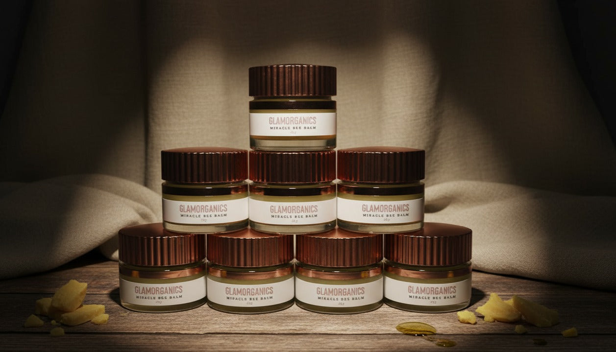 Glamorganics bee balm Jars of a product with a brand label on a wooden surface